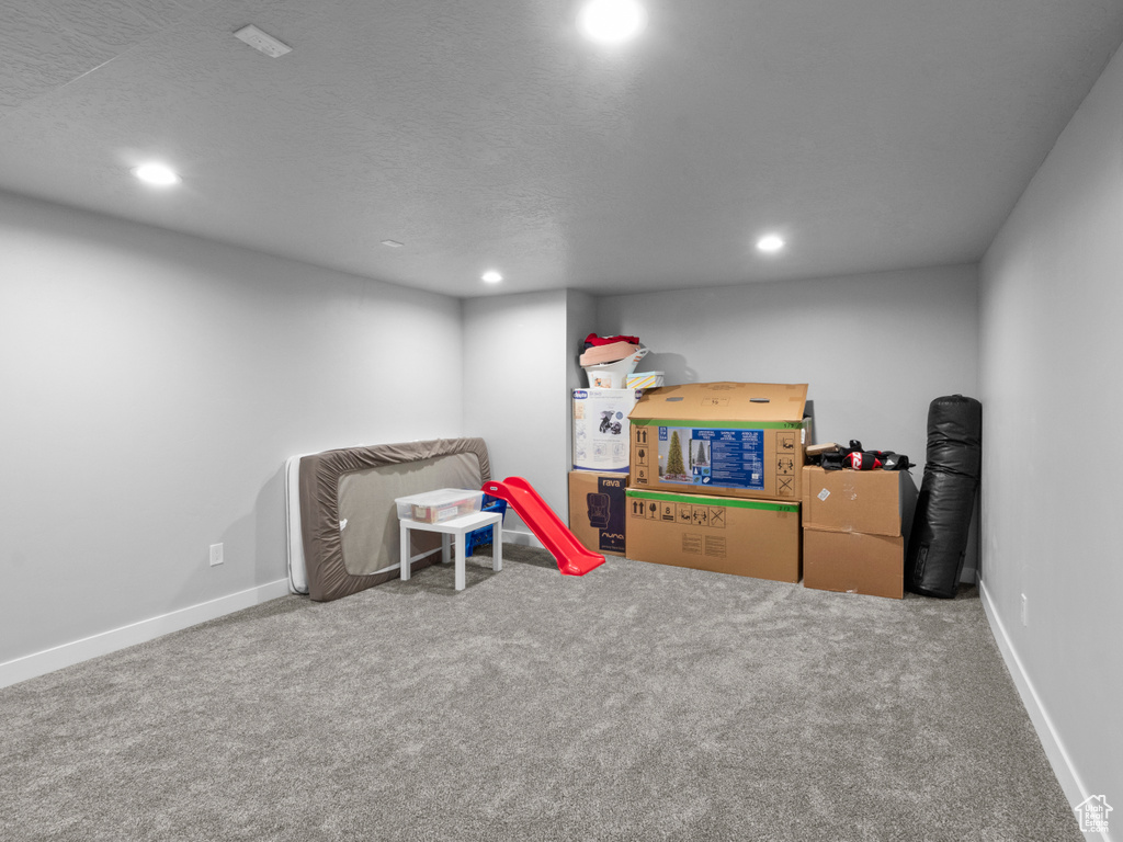 Recreation room featuring recessed lighting, carpet, baseboards, and a textured ceiling