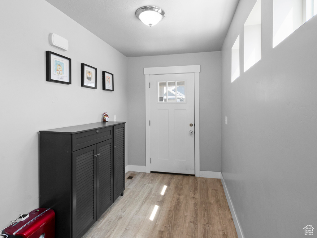 Entryway featuring light wood-style floors and baseboards