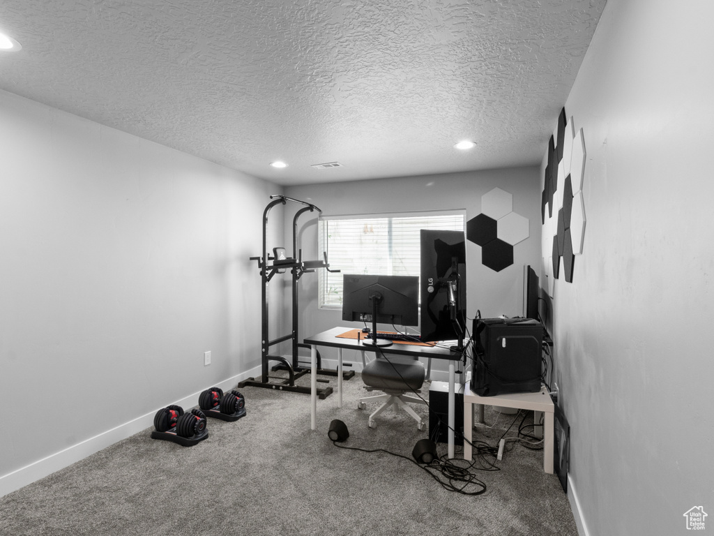Workout room with a textured ceiling, recessed lighting, baseboards, and carpet floors