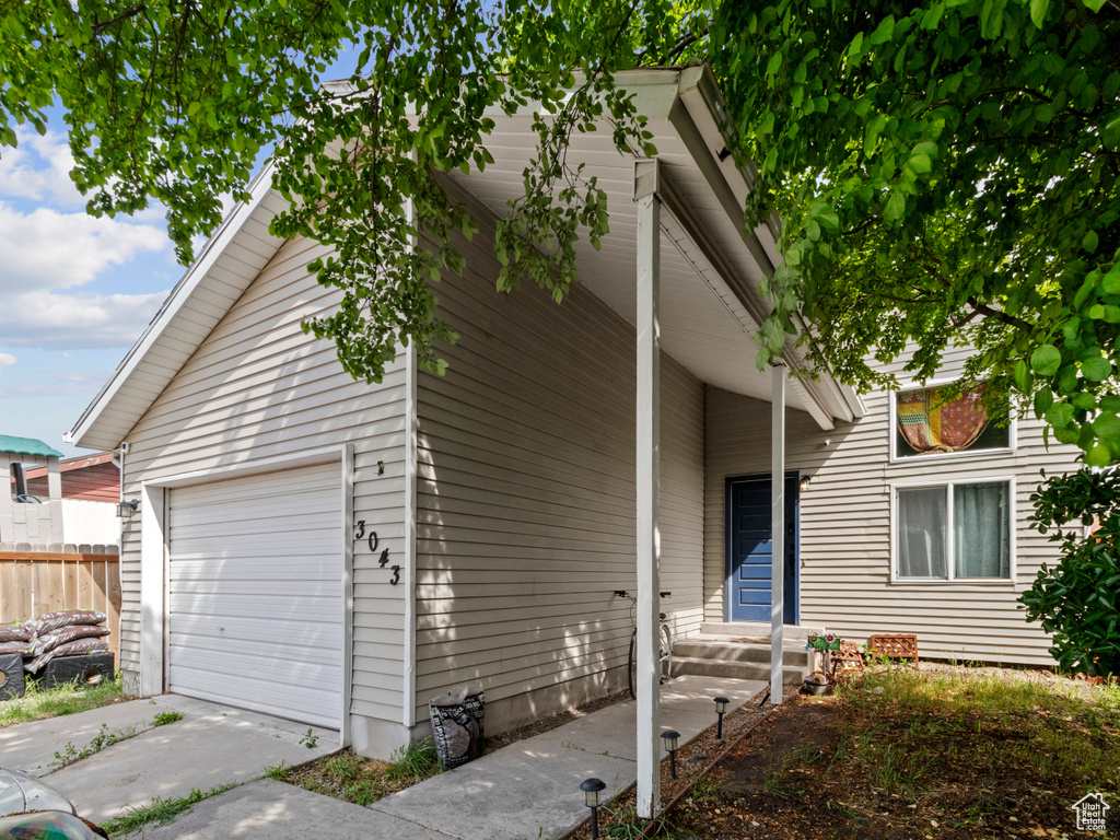 View of front of home featuring fence