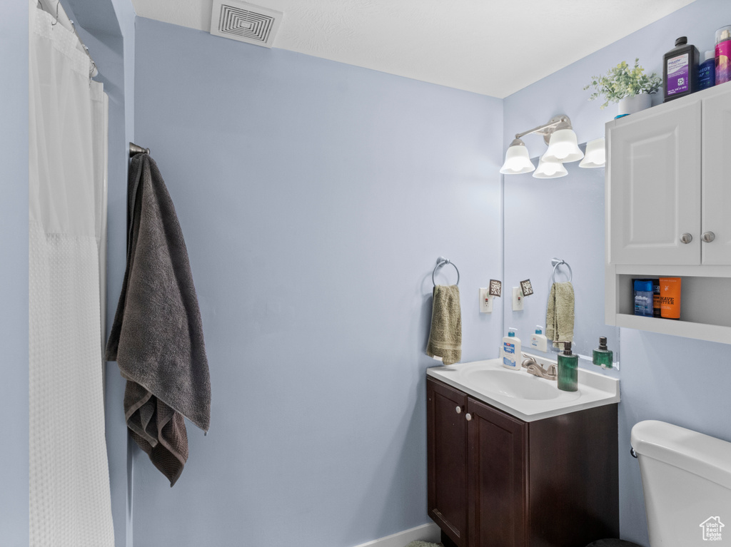 Full bath featuring vanity and toilet