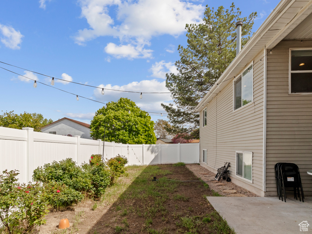 Fenced backyard with a patio area