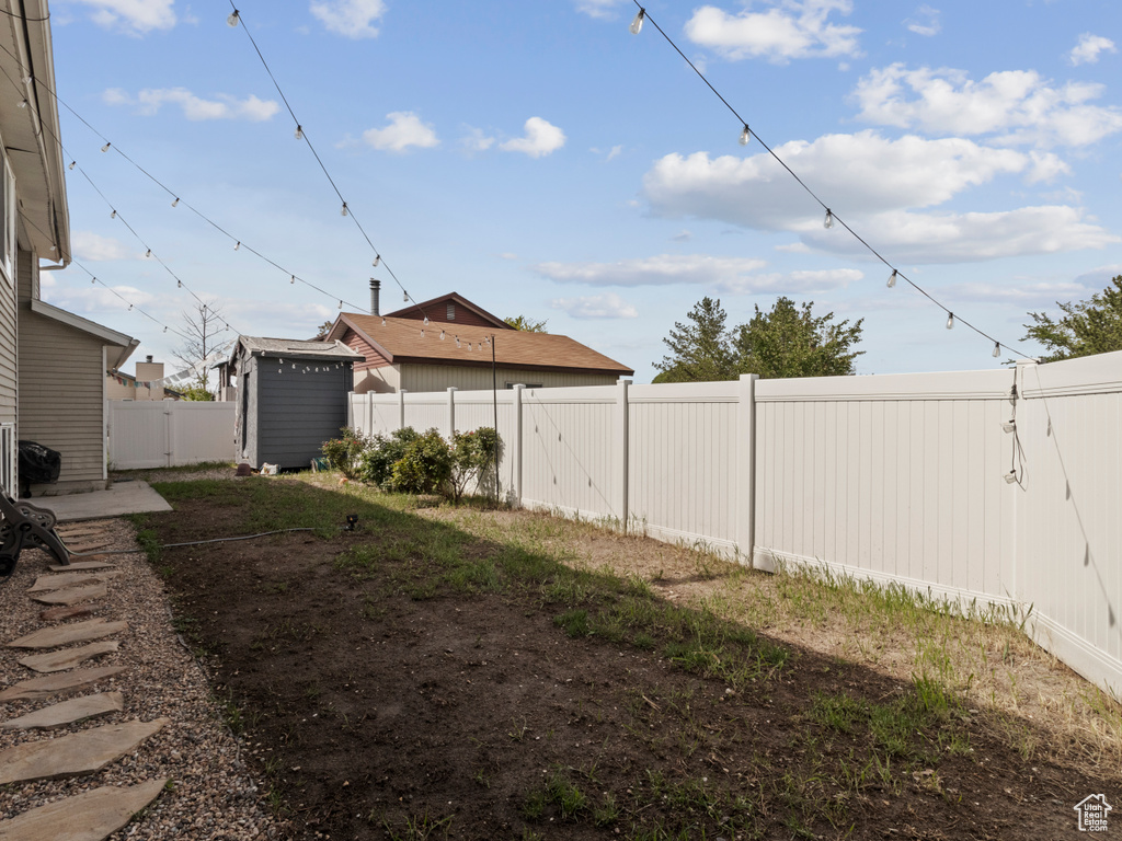 Fenced backyard with a shed and an outbuilding