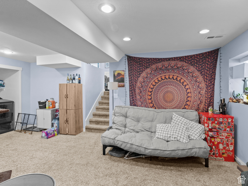 Living room featuring carpet flooring, recessed lighting, and stairs