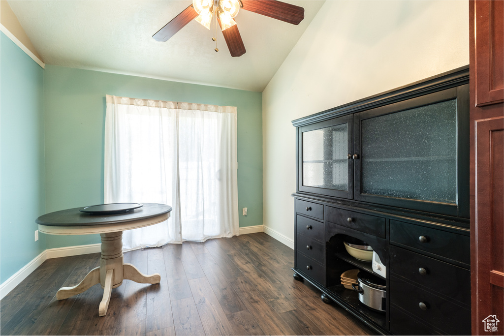 Miscellaneous room with baseboards, a ceiling fan, dark wood-style floors, and vaulted ceiling
