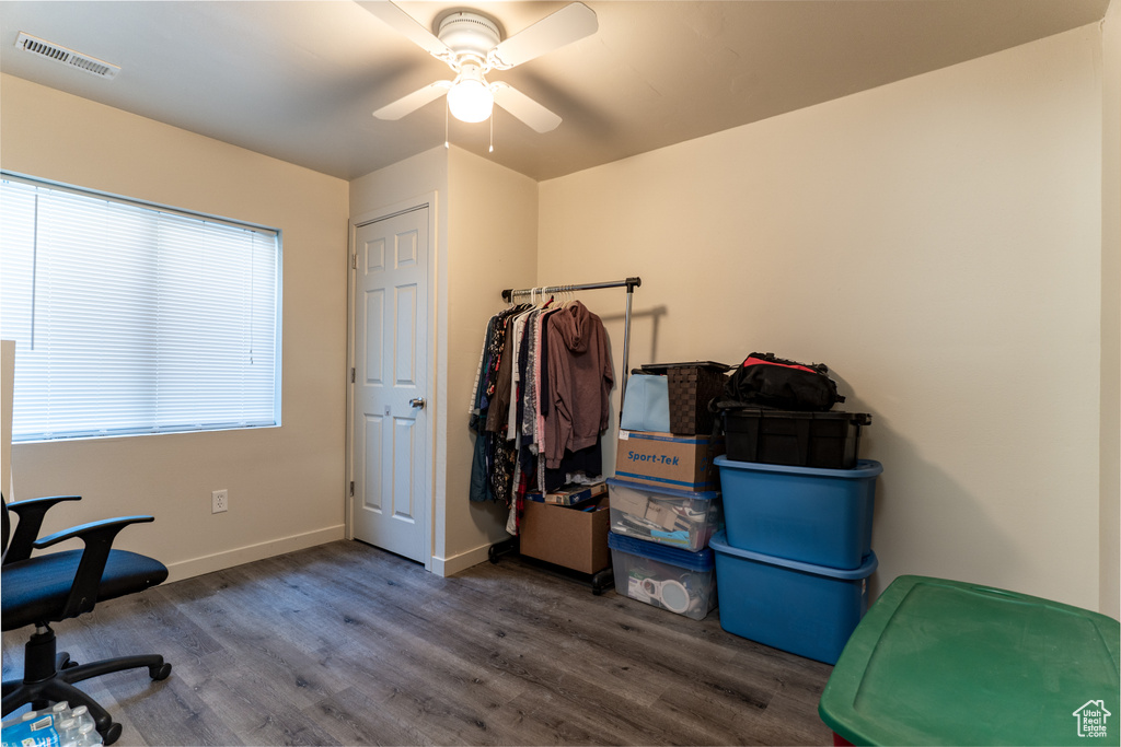 Office area with wood finished floors, a ceiling fan, and baseboards