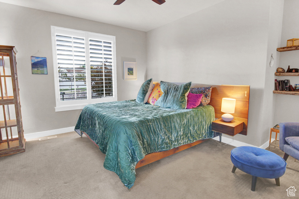 Bedroom featuring carpet flooring, baseboards, and ceiling fan