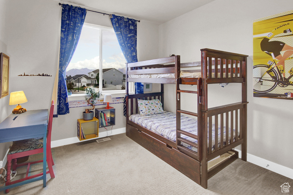 Carpeted bedroom featuring baseboards