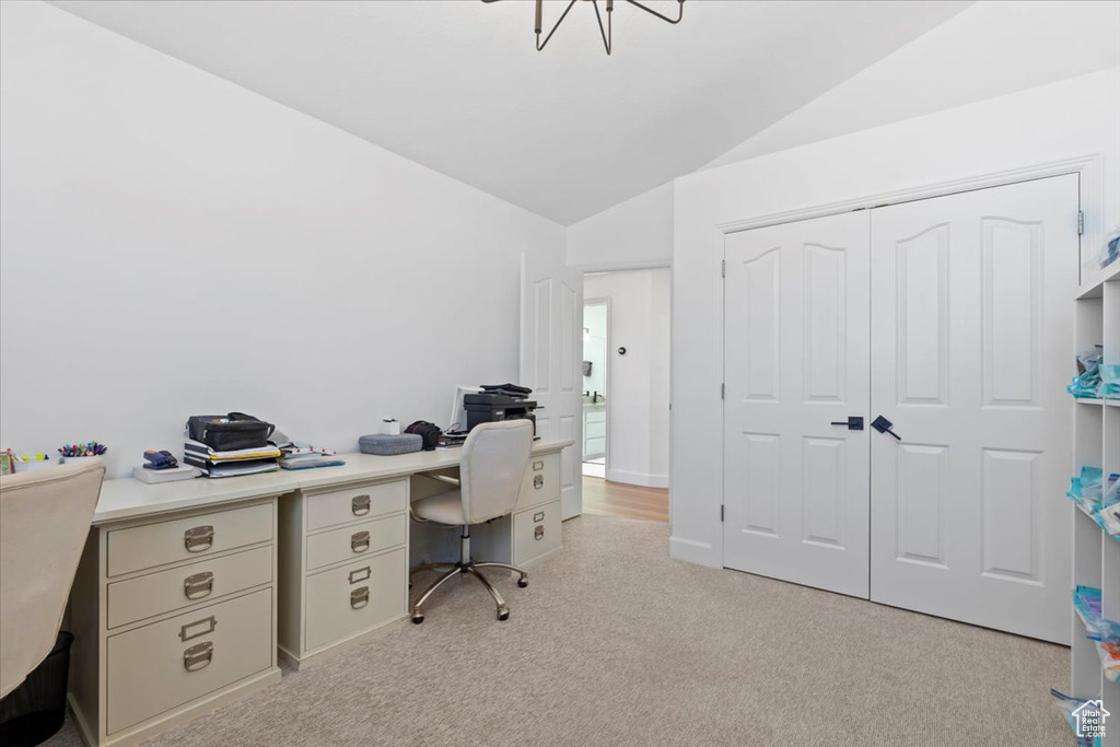 Office featuring lofted ceiling and light carpet