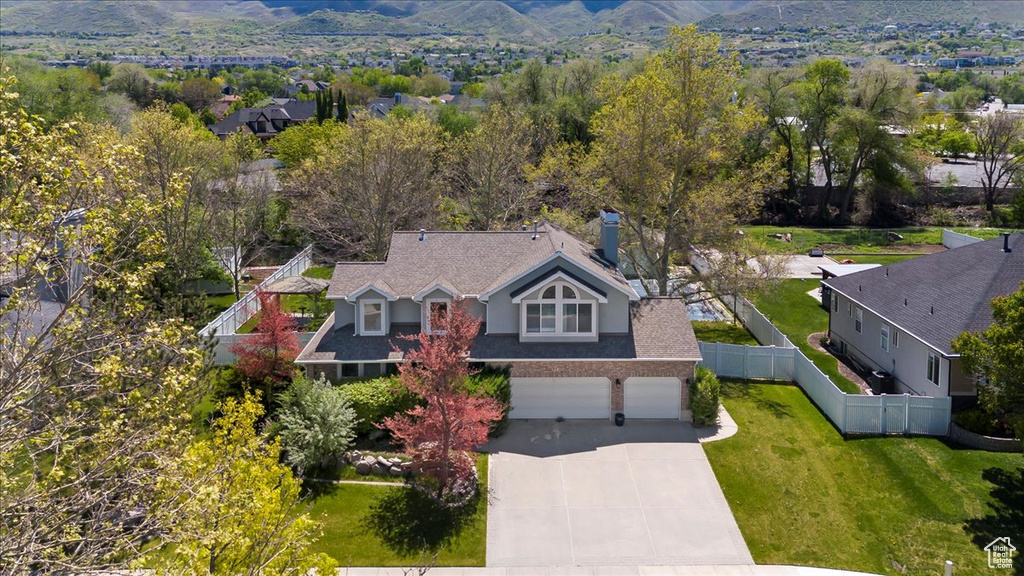 Aerial view of property and surrounding area with a mountainous background
