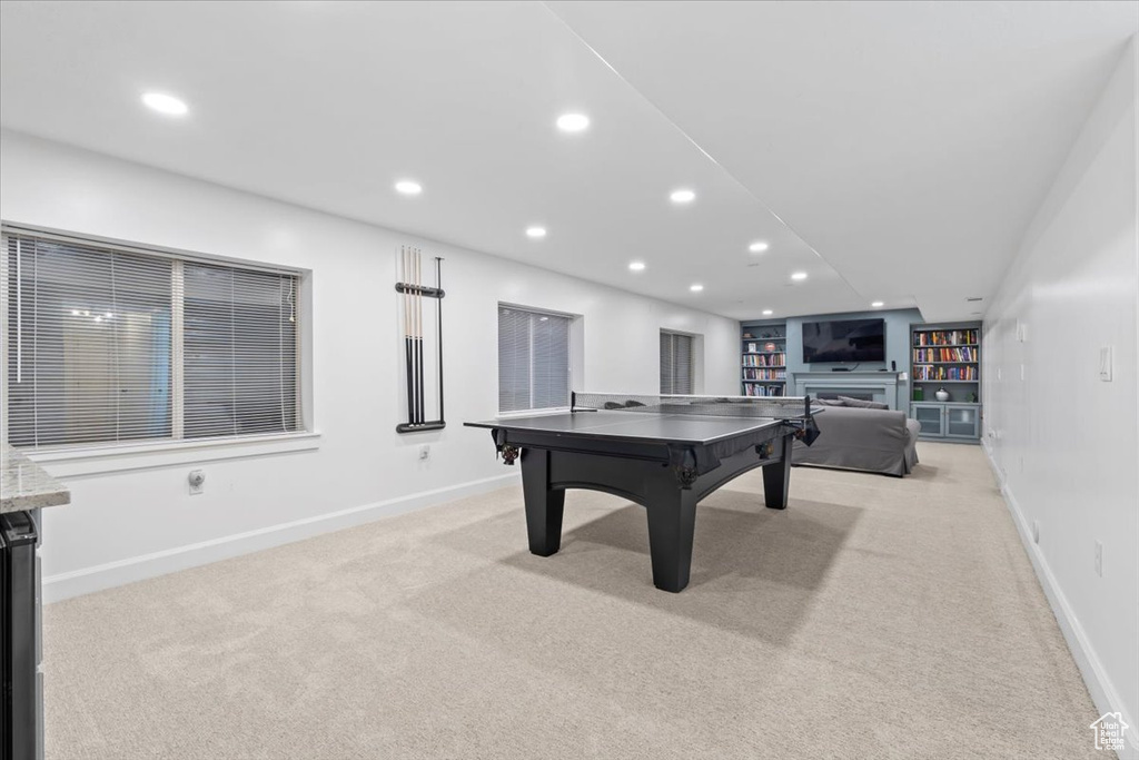 Recreation room featuring light carpet, recessed lighting, a fireplace, and baseboards