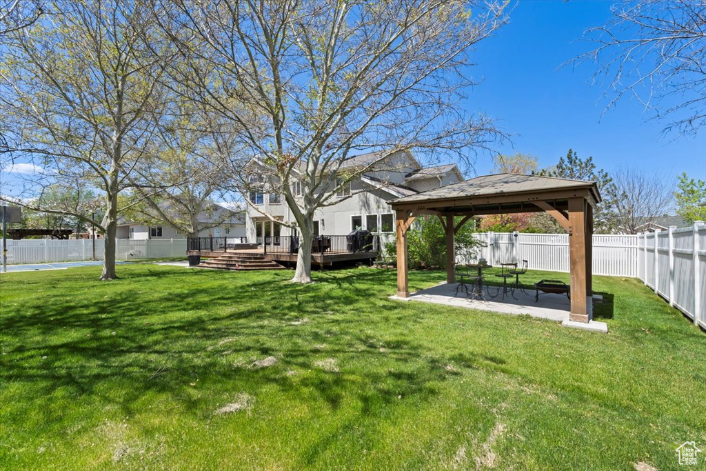 View of yard featuring a gazebo, a wooden deck, and a patio area