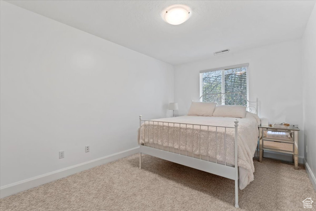 Carpeted bedroom with baseboards