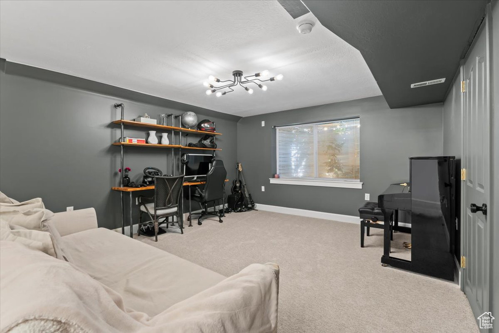 Bedroom featuring a desk, carpet floors, baseboards, and a chandelier