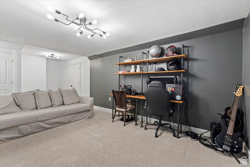 Office space featuring carpet flooring, baseboards, and a textured ceiling