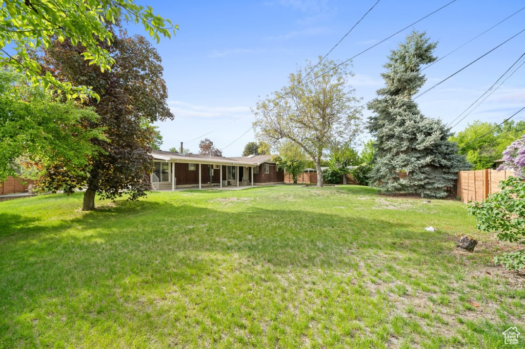 View of yard with a sunroom