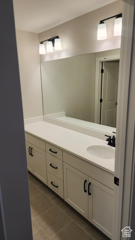 Bathroom with tile patterned flooring and vanity