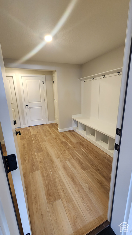 Mudroom featuring light wood-type flooring and baseboards