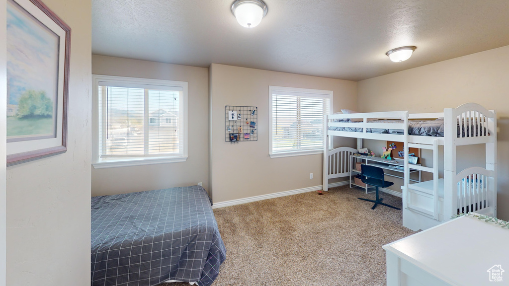 Carpeted bedroom with baseboards