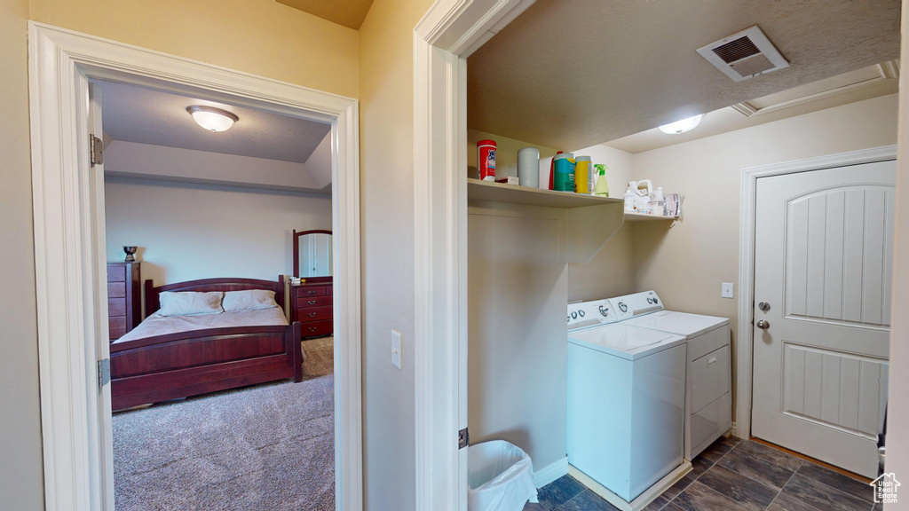Laundry area featuring attic access, washing machine and clothes dryer, and baseboards