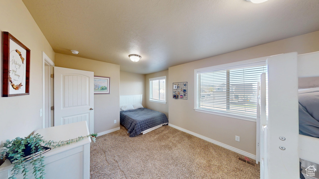 Bedroom with light carpet and baseboards