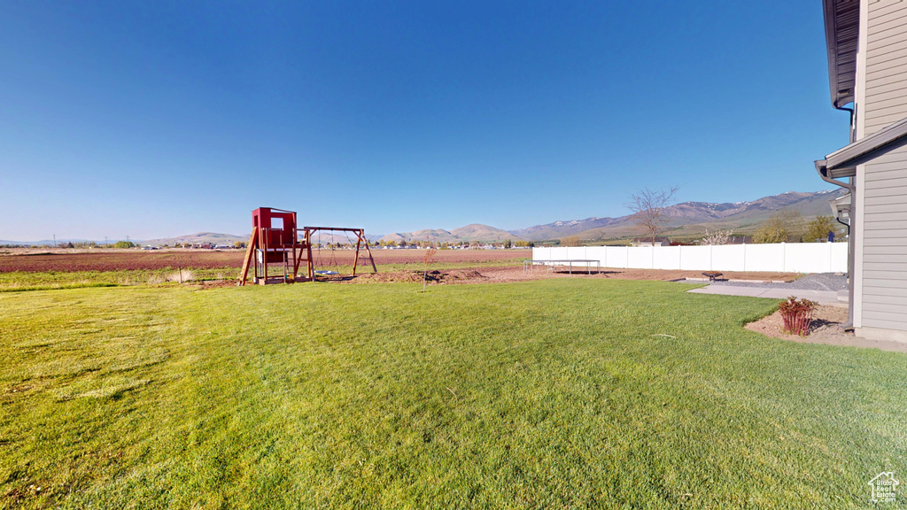 View of yard with a mountain view and a playground