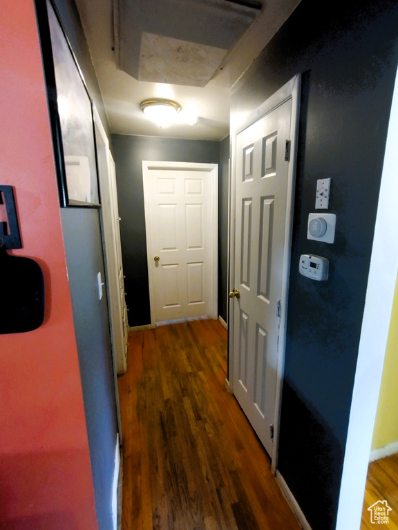 Corridor with wood finished floors and baseboards