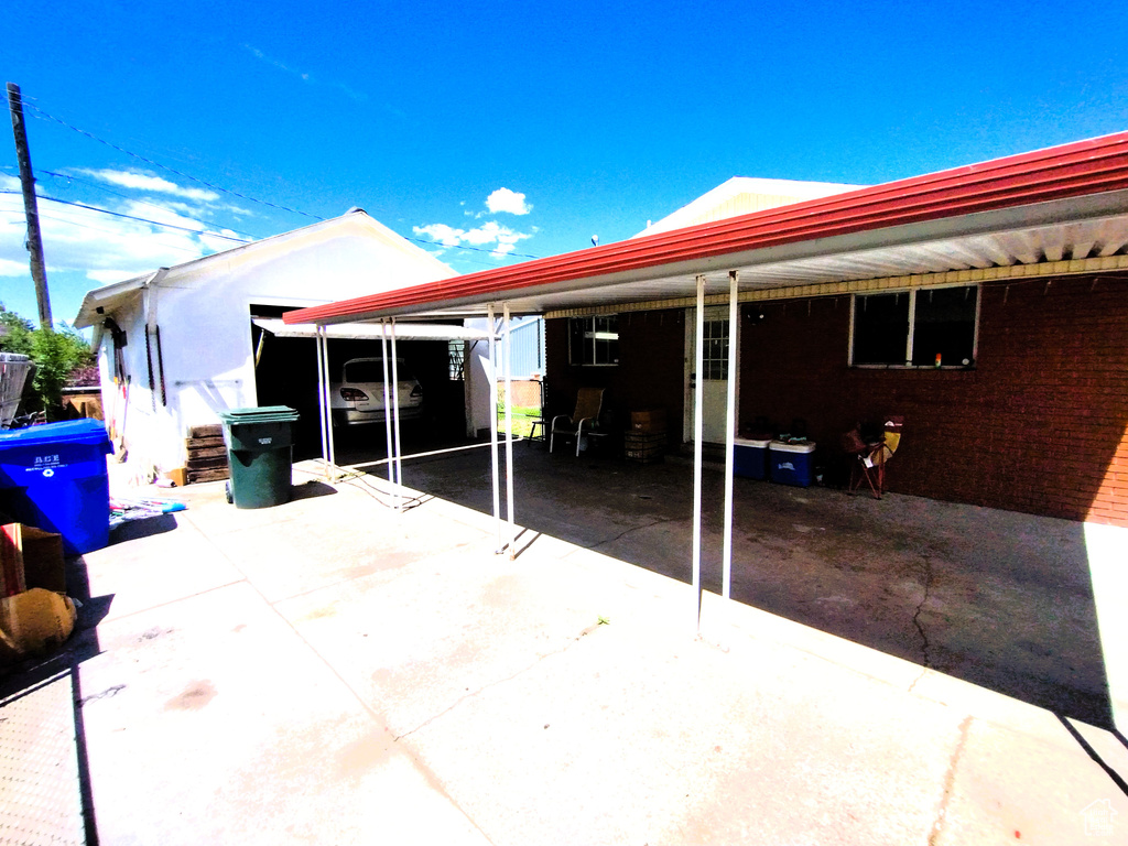 Rear view of house featuring an attached carport