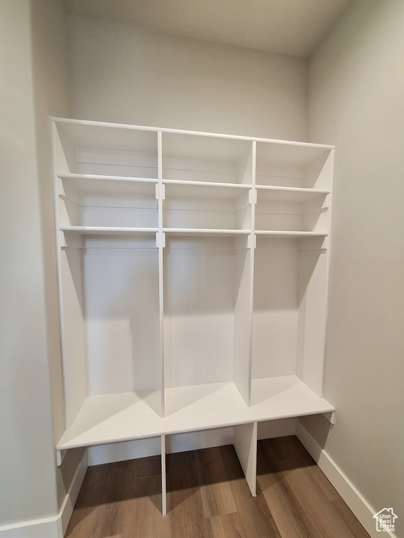 Mudroom with wood finished floors and baseboards