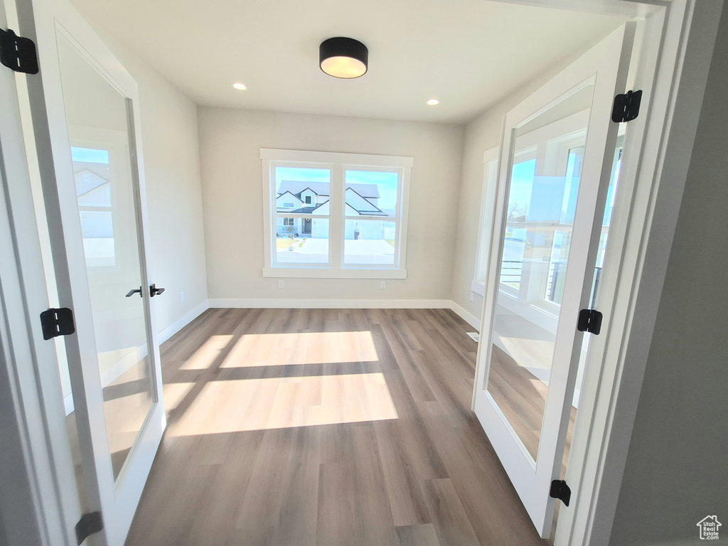 Entryway featuring wood finished floors, baseboards, and recessed lighting