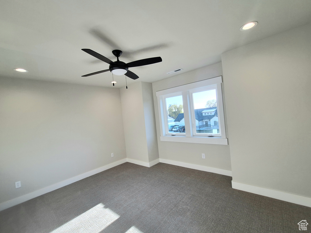 Unfurnished room with dark carpet, recessed lighting, baseboards, and ceiling fan