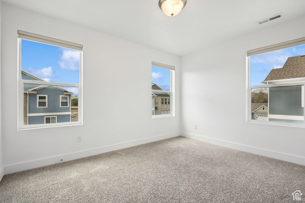 Empty room with carpet and baseboards