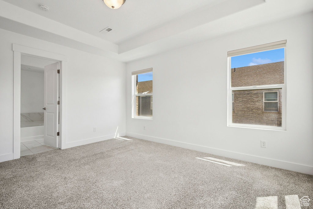 Spare room with carpet, a smoke detector, and baseboards