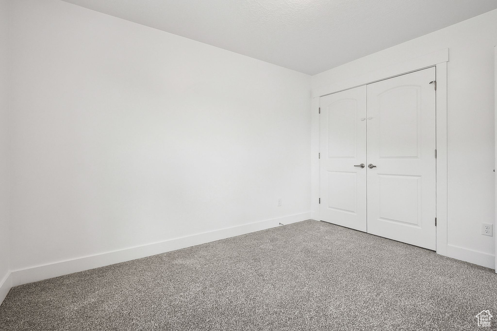 Unfurnished bedroom with baseboards and a closet