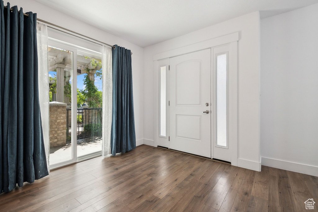 Entryway with hardwood / wood-style floors and baseboards