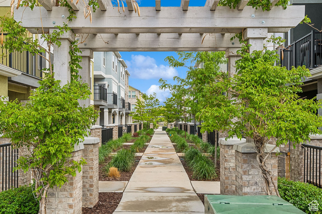 View of property\'s community featuring a pergola and a residential view
