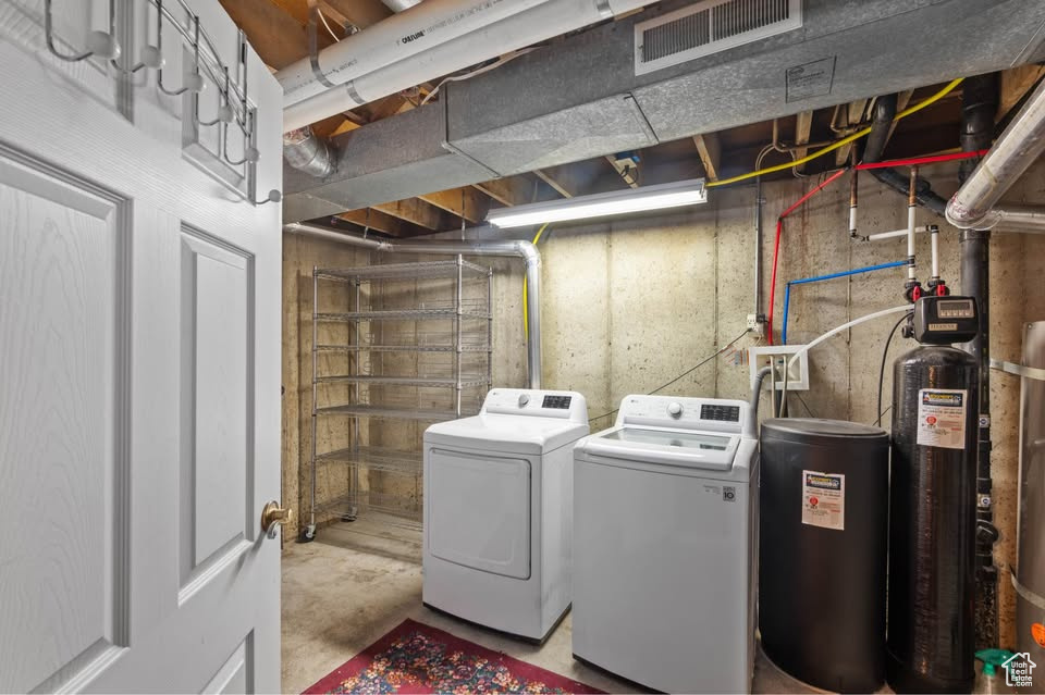Washroom with washer and clothes dryer