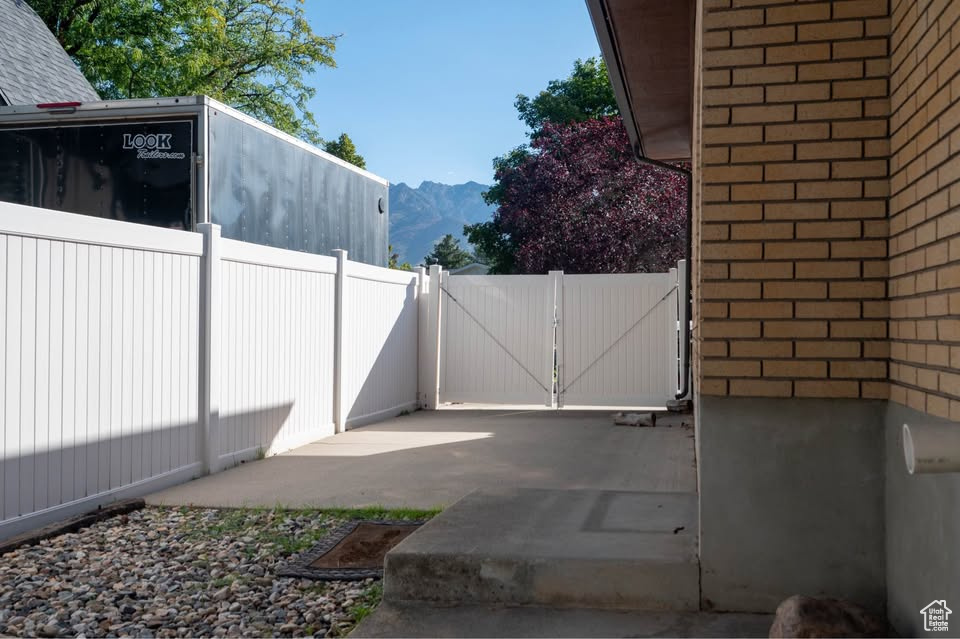 Gate featuring a mountain view and fence