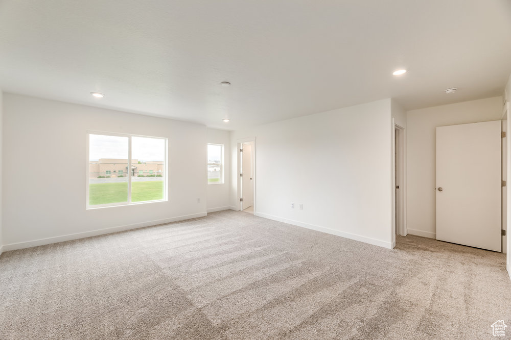 Unfurnished room with light carpet, recessed lighting, and baseboards