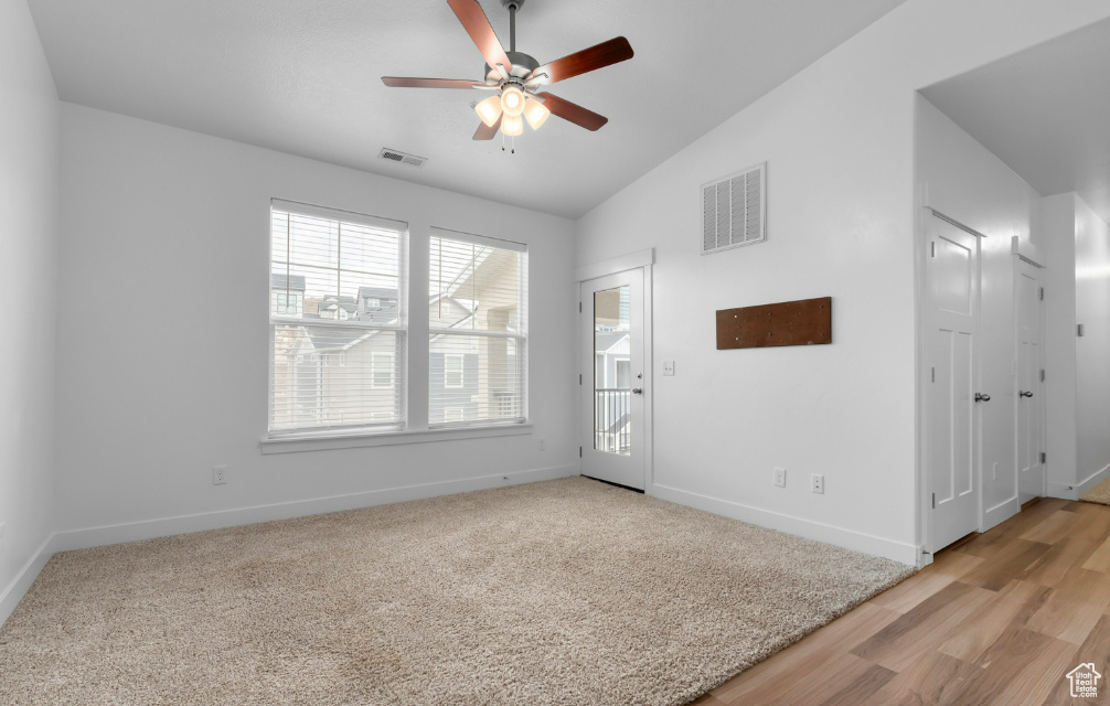 Unfurnished room featuring vaulted ceiling, ceiling fan, and baseboards