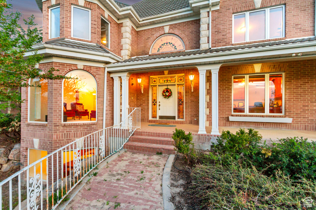 Property entrance with brick siding and covered porch
