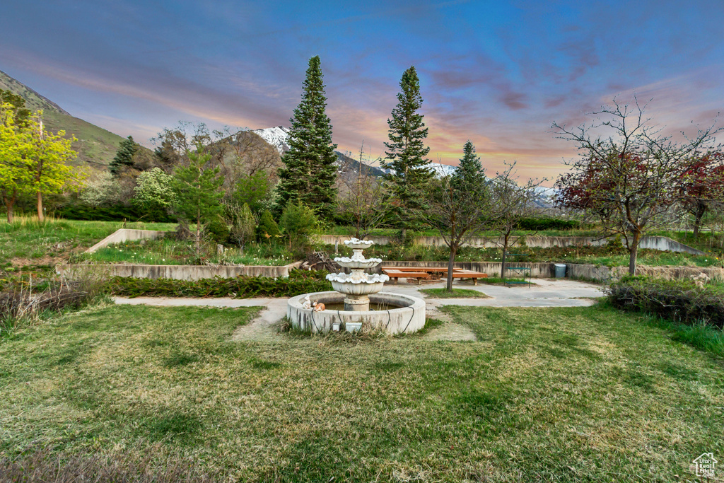 View of green lawn featuring a mountain view