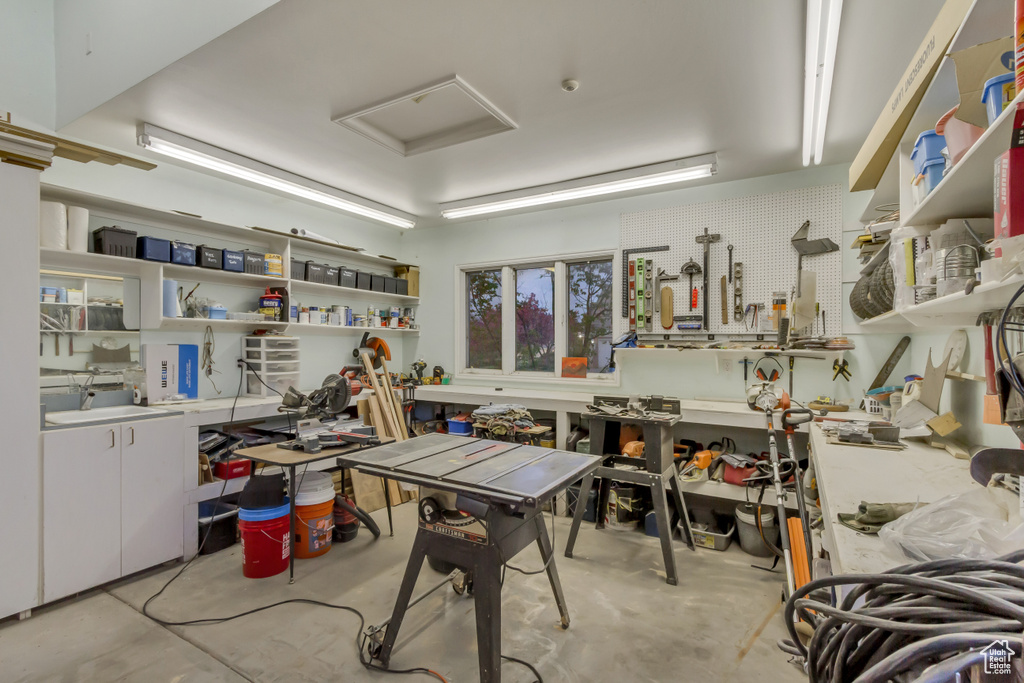 Misc room featuring a workshop area and concrete floors