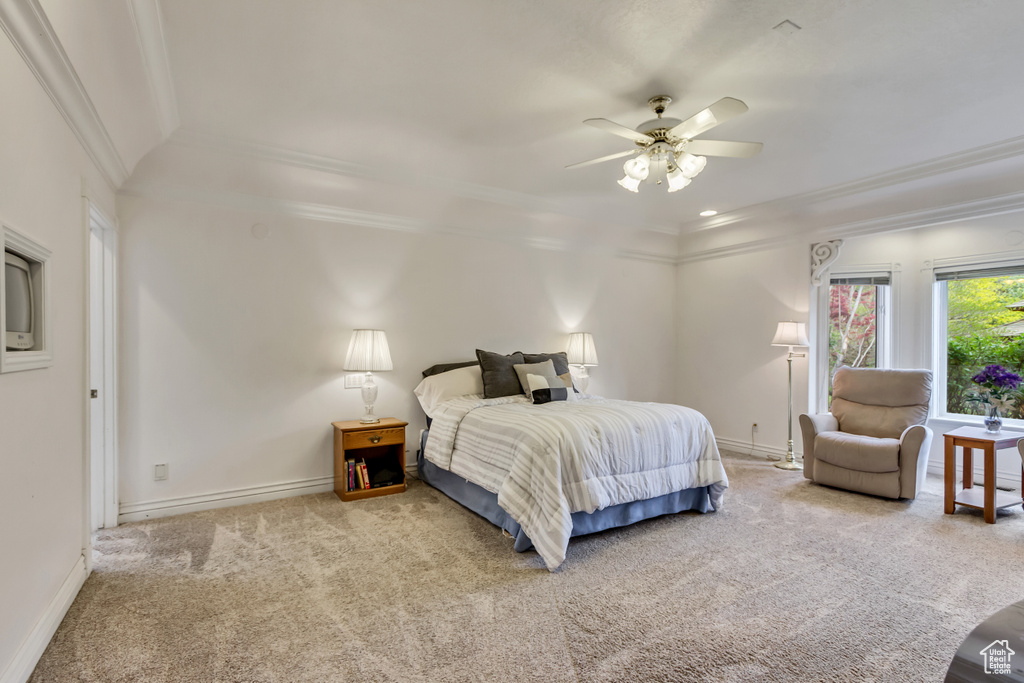 Bedroom with carpet flooring, crown molding, baseboards, and a ceiling fan
