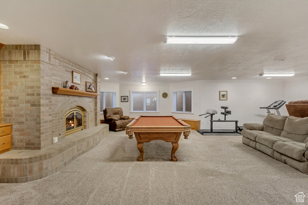 Game room featuring billiards, carpet flooring, a fireplace, and ornamental molding