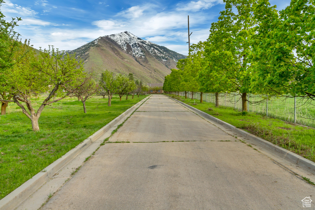 View of concrete street with curbs and a mountain view
