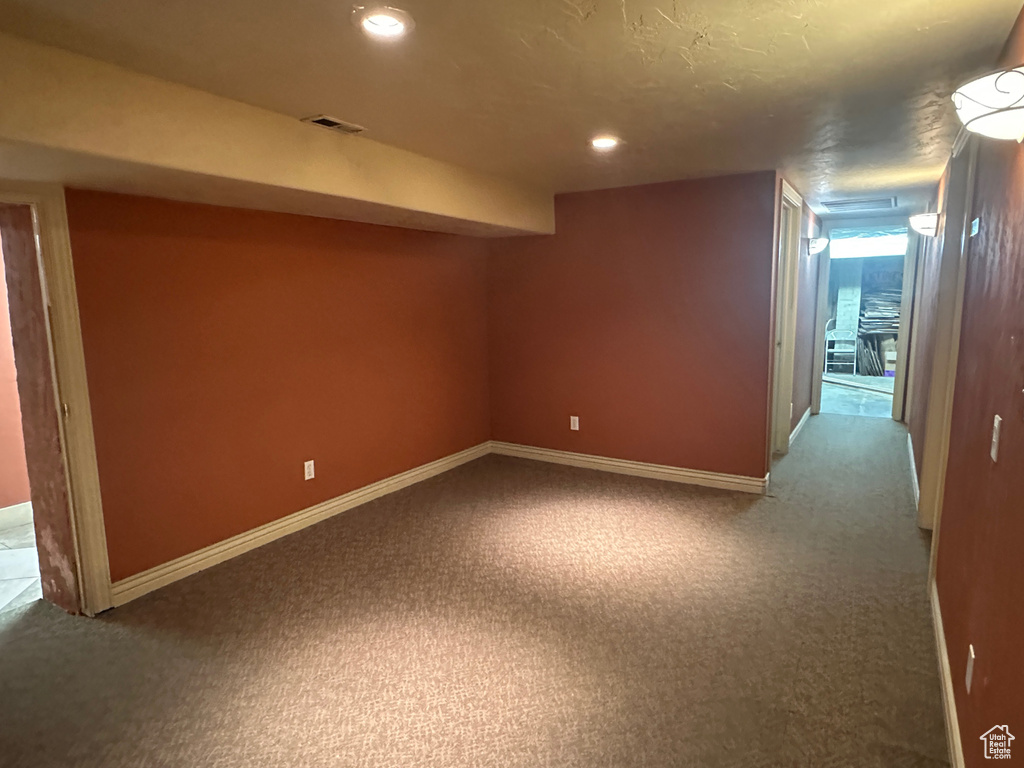 Basement featuring carpet floors, baseboards, and recessed lighting