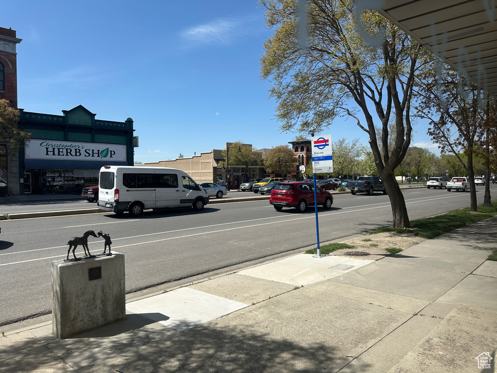 View of asphalt street featuring sidewalks and curbs