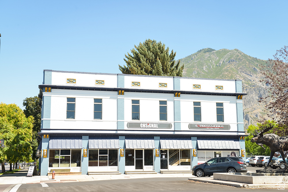 View of commercial property featuring a mountain view and uncovered parking