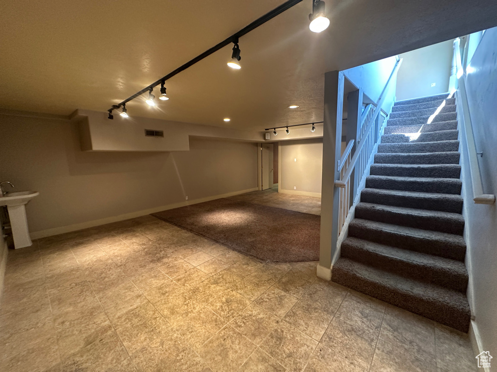 Staircase with rail lighting and baseboards